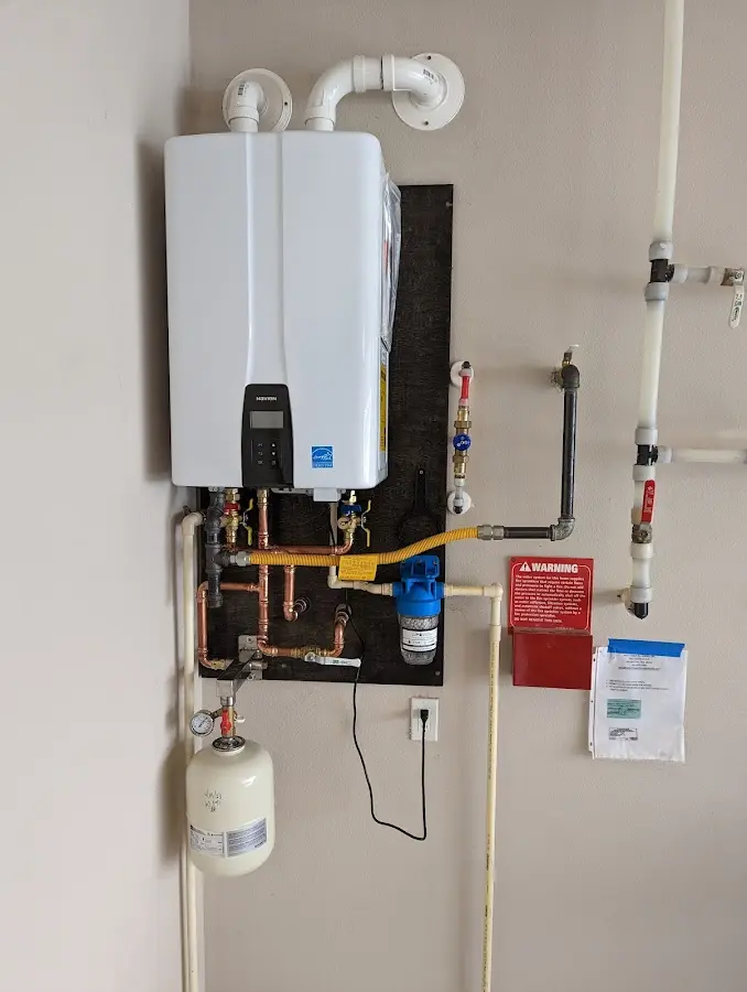 Professional plumber installing copper piping in a Novi home